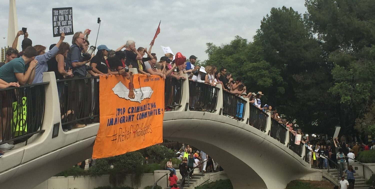 Photo of protestors standing on bridge